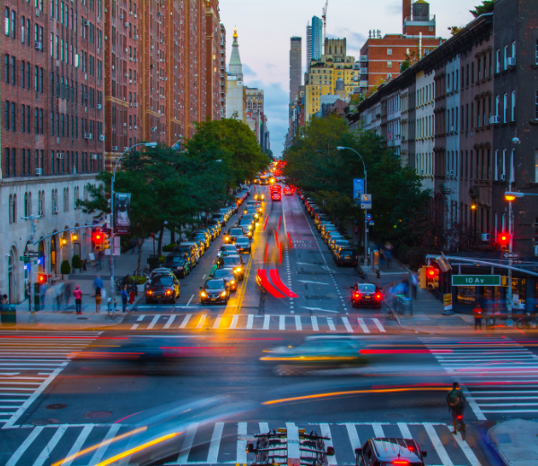 Busy New York City street with car lights blurred in movement