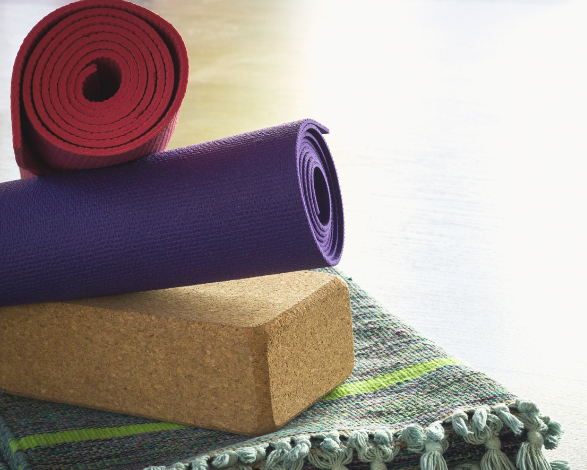 Yoga props, including 2 yoga mats, a block, and a blanket for additional support