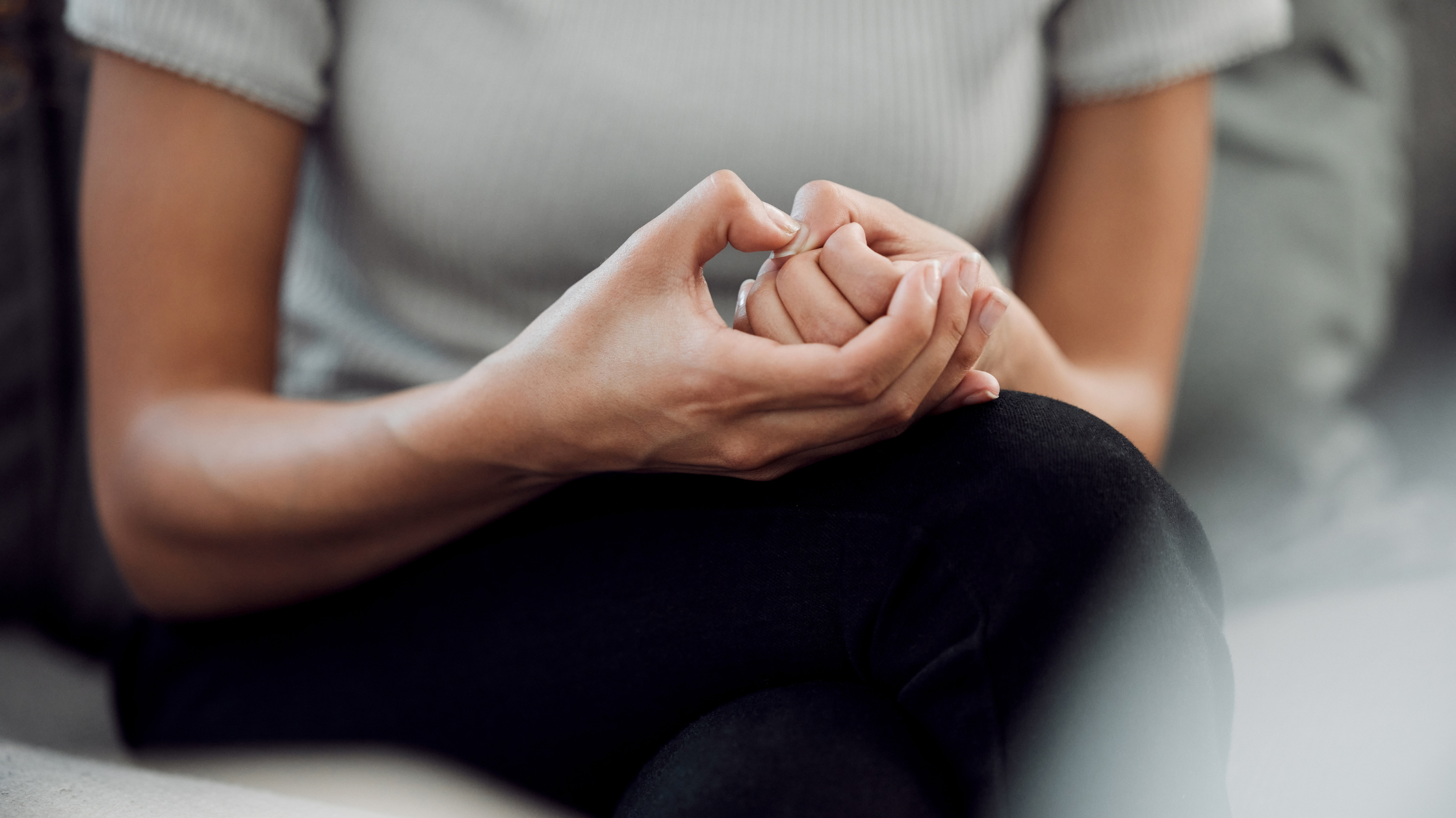 Woman picking at her skin, a sign of anxiety