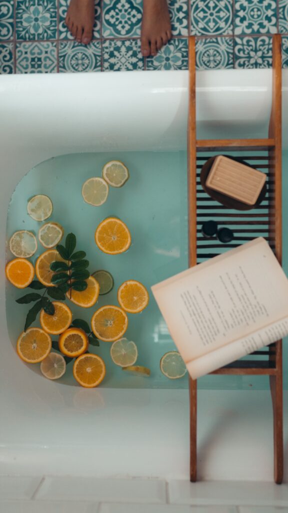 A woman prepares to get into a healing bath of citrus and herbs to practice self-care. Learn how to find balance in life with the help of Anxiety Therapy for Women in Manhattan, NY.