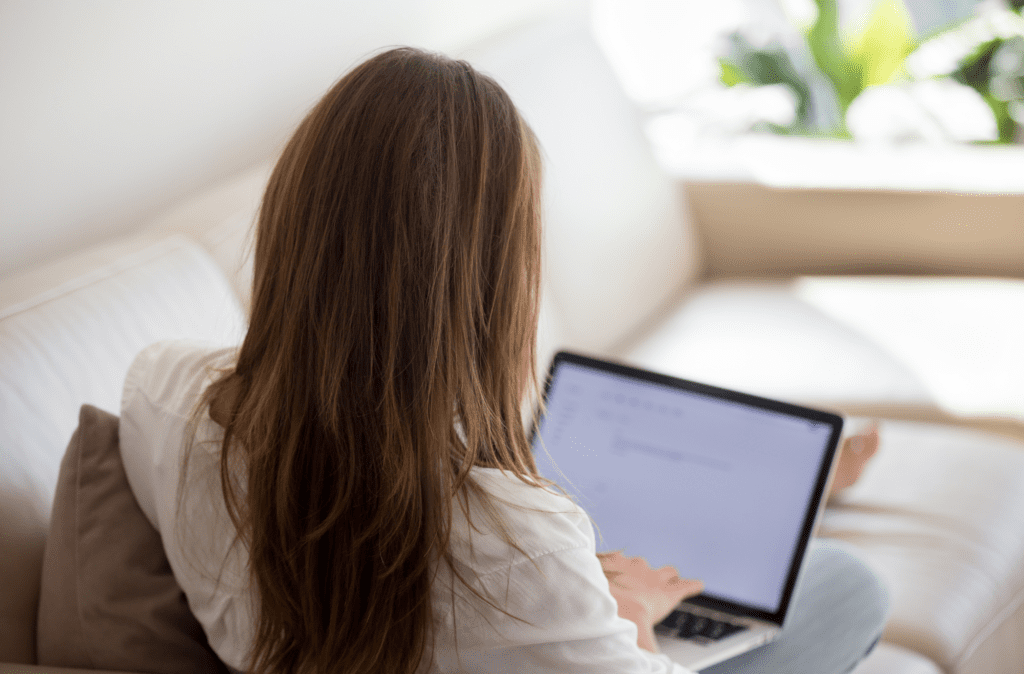Woman using a laptop to read a newsletter