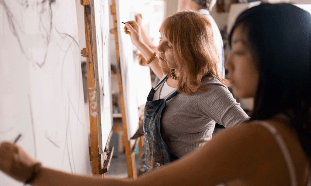 Two women drawing at an adult art class