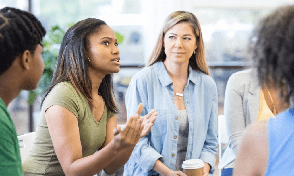 Woman sharing her thoughts at a group therapy session