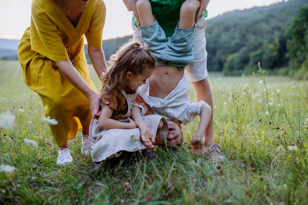 Parents play with their children as they laugh representing a family who has benefited from Therapy for Special Needs Parenting in Manhattan, NY.