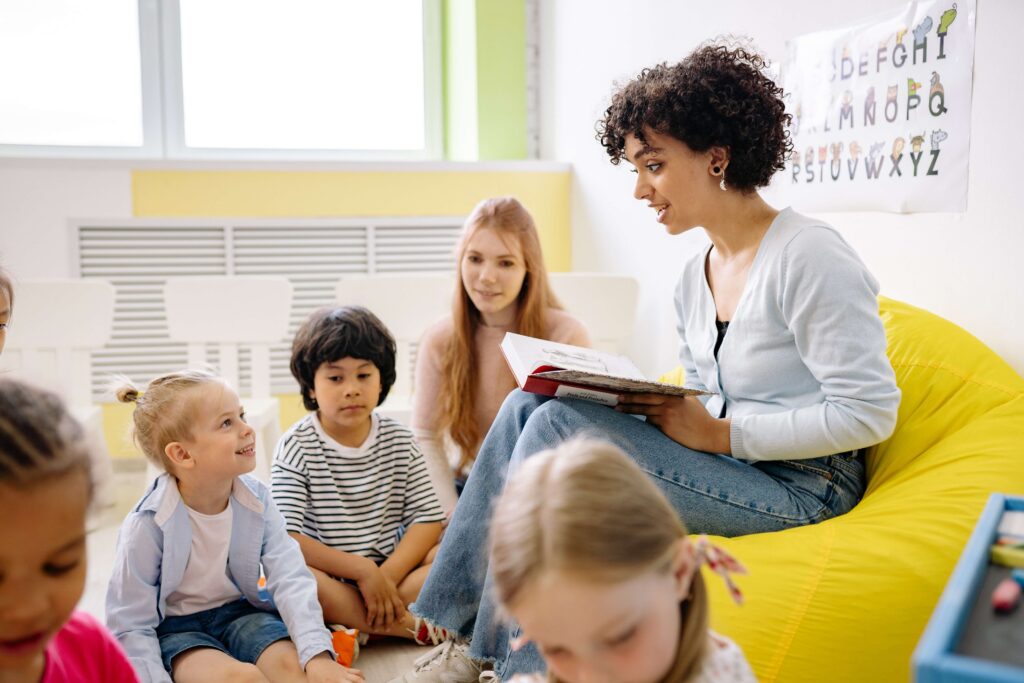 A teacher reads to a group of students. The new school year can bring stress for parents and children alike. Therapy for Anxiety in NYC can help.