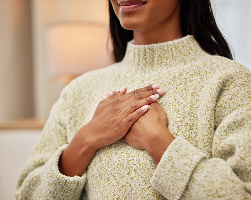 woman with hands on heart after anxiety therapy in NYC