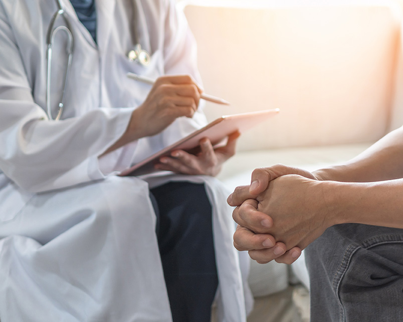 Young man discussing physical injury with doctor