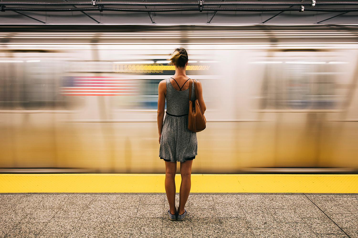 Woman waiting for the subway; Therapy for women's mental health in NYC