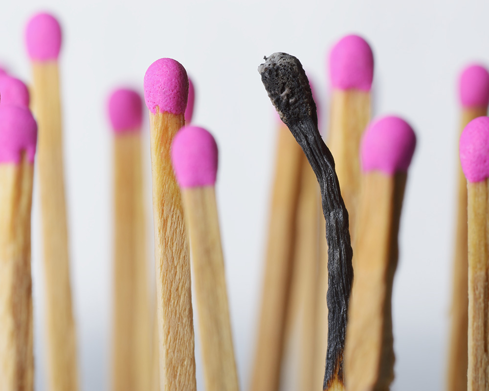Burnt match representing burnout and work-life balance